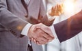 Building a strong business network. two businessmen shaking hands in a modern office. Royalty Free Stock Photo