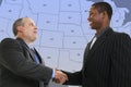 Businessmen Handshake in Front of Blue US State Map