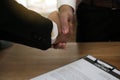 Businessmen handshake to invest and share profits in building and residential projects. Have a contract document that has legal