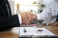 Businessmen handshake to invest and share profits in building and residential projects. Have a contract document that has legal