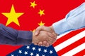 Businessmen handshaking on Usa or American and China flags merged politic and economic relationships concept