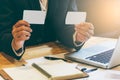 Businessmen hold 2 credit cards in both hands