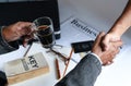 Businessmen holding coffee cup are shake hands. Royalty Free Stock Photo