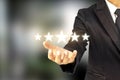 Businessmen are holding five stars, raising their rank or raising the highest ratings.