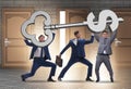 Businessmen holding giant key in finance concept Royalty Free Stock Photo