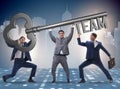 Businessmen holding giant key in team concept Royalty Free Stock Photo