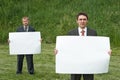 Businessmen holding sheet of paper