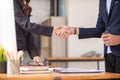 Businessmen and investors shake hands after attending meeting with advisory team after receiving advice from advisory team about