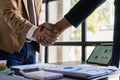 Businessmen join hands for teamwork in business mergers and acquisitions, successful
