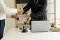 Businessmen and lawyers shake hands Businessman offers money with dollar bills in hand to pay bribes to agreed lawyers and corrupt Royalty Free Stock Photo