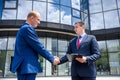 Businessmen making deal and handshaking outside building Royalty Free Stock Photo