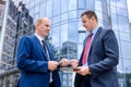 Businessmen making deal and handshaking outside building Royalty Free Stock Photo