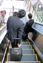 Businessmen on moving staircase Royalty Free Stock Photo