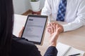 Businessmen open the resume for the applicant in an email via tablet during a job interview. Employment concept