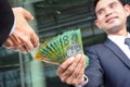 Businessmen passing money, Australia dollar banknotes