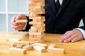 Businessmen picking dominoe blocks to fill the missing dominoes. Growing business concept