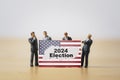 Businessmen and politician miniature figure standing with USA flag for 2024 year United States of America have President election