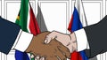 Businessmen or politicians shake hands against flags of South Africa and Russia. Official meeting or cooperation related