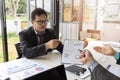 Businessmen present earnings report , the monthly college budget, financial chart to colleagues in the meeting