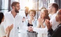 Businessmen reach out to each other to shake hands