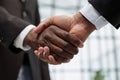 Businessmen reach out to each other to shake hands