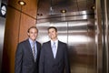 Businessmen riding in elevator