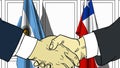 Businessmen or politicians shake hands against flags of Argentina and Chile. Official meeting or cooperation related