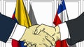 Businessmen or politicians shake hands against flags of Colombia and Chile. Official meeting or cooperation related