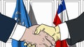 Businessmen or politicians shake hands against flags of United Nations and Chile. Official meeting or cooperation