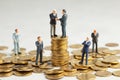 Businessmen shake hands as a symbol of a successful profitable transaction. Businessmen on a stack of gold coins as a symbol of