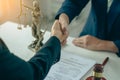 Businessmen shake hands after consulting the law from lawyers, judges, and legal counsel. Consulting services on various contracts