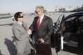 Businessmen Shaking Hands At Airfield