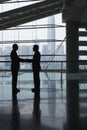 Businessmen Shaking Hands In Airport Terminal Royalty Free Stock Photo