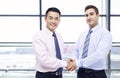 Businessmen shaking hands at airport