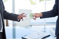 Businessmen shaking hands and exchanging money Royalty Free Stock Photo