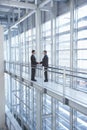 Businessmen Shaking Hands In Modern Office