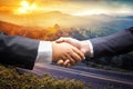 Businessmen shaking hands on nature sunset mountain background