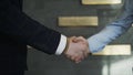 Businessmen shaking hands in the office, closeup. Action. Good deal, business concept, two men shaking hands on the Royalty Free Stock Photo