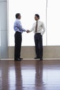 Businessmen Shaking Hands In Office Royalty Free Stock Photo