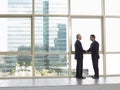 Businessmen Shaking Hands In Office Royalty Free Stock Photo