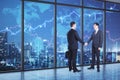 Businessmen shaking hands in office interior with night city view and forex chart. Teamwork concept Royalty Free Stock Photo