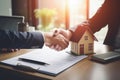 Businessmen shaking hands in a real estate agency. The conclusion of a business transaction with real estate. Confirmation of the Royalty Free Stock Photo