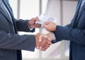 Businessmen shaking hands and receiving money Royalty Free Stock Photo