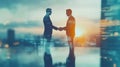 Businessmen shaking hands on the table with blurred documents and a computer in the office Royalty Free Stock Photo