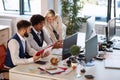 Businessmen showing their progress to the boss. Coworkers looking at the computer and talking about business