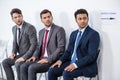 Businessmen sitting in queue and waiting for interview in office