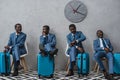 Businessmen sitting in a waiting room with suitcases, same man Royalty Free Stock Photo