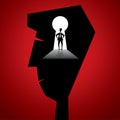 Businessmen stand in key hole in people head