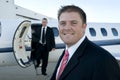 Businessmen standing in front of corporate jet Royalty Free Stock Photo