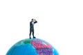 Businessmen standing using binoculars above earth globe. Miniature tiny people toys photography. isolated on white background Royalty Free Stock Photo